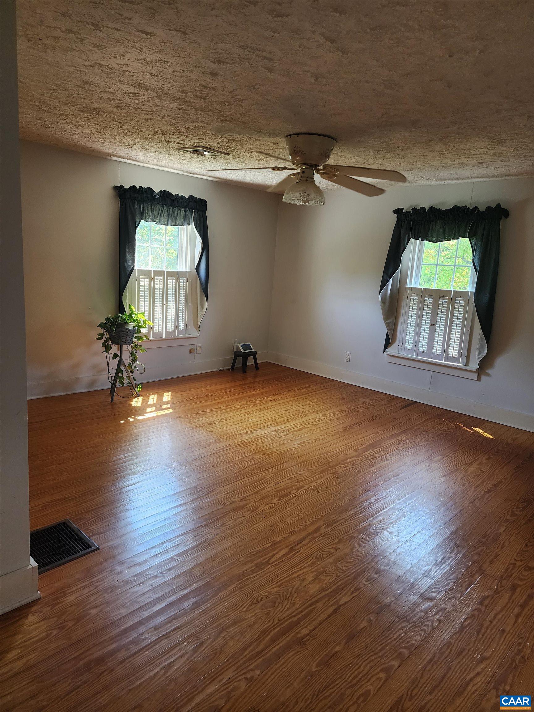 10778 Rockfish River Road Shipman, VA 22971 - Photo 31 of 67 an empty room with wooden floor table and chairs