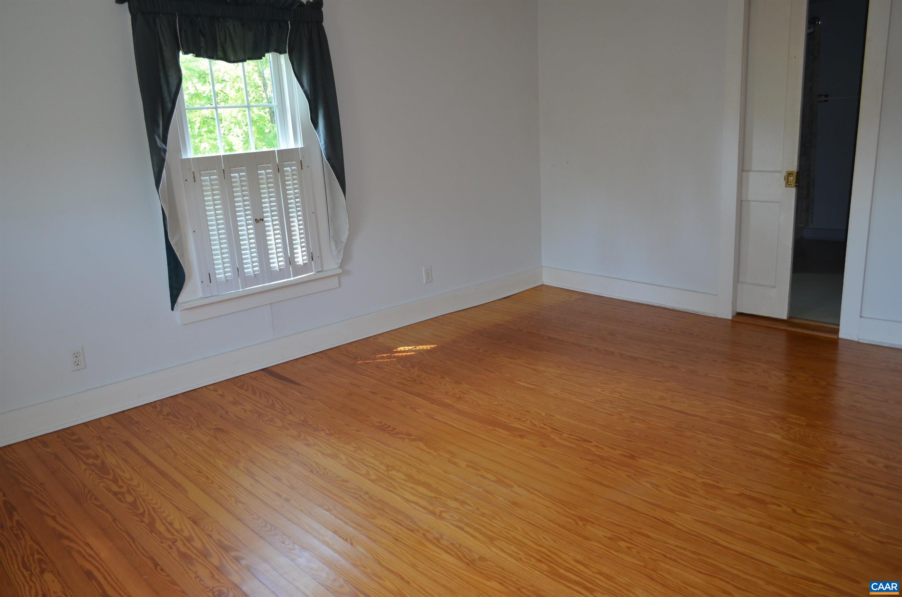 10778 Rockfish River Road Shipman, VA 22971 - Photo 32 of 67 an empty room with wooden floor and windows