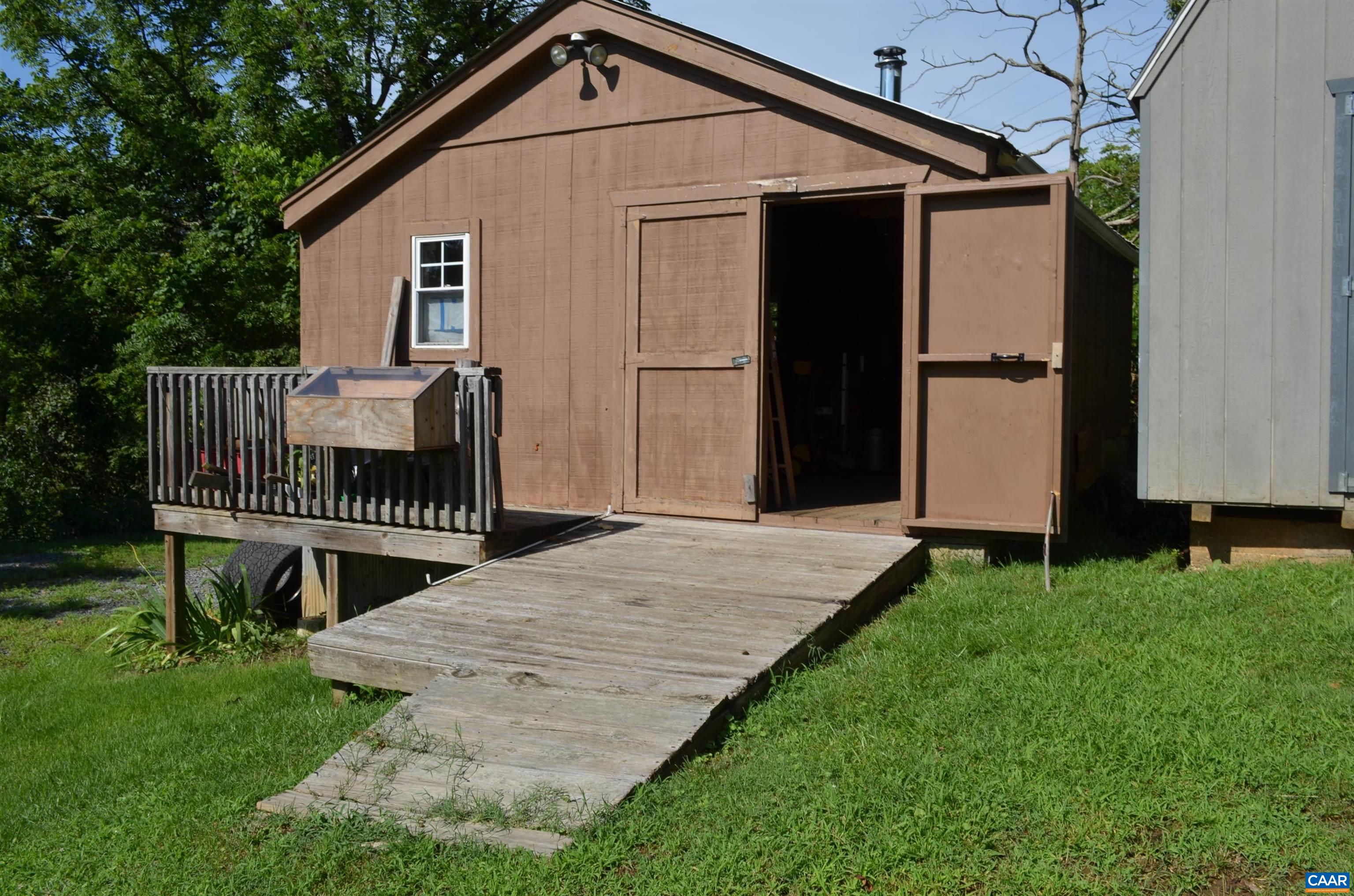 10778 Rockfish River Road Shipman, VA 22971 - Photo 59 of 67 a view of a house with a small yard and wooden fence