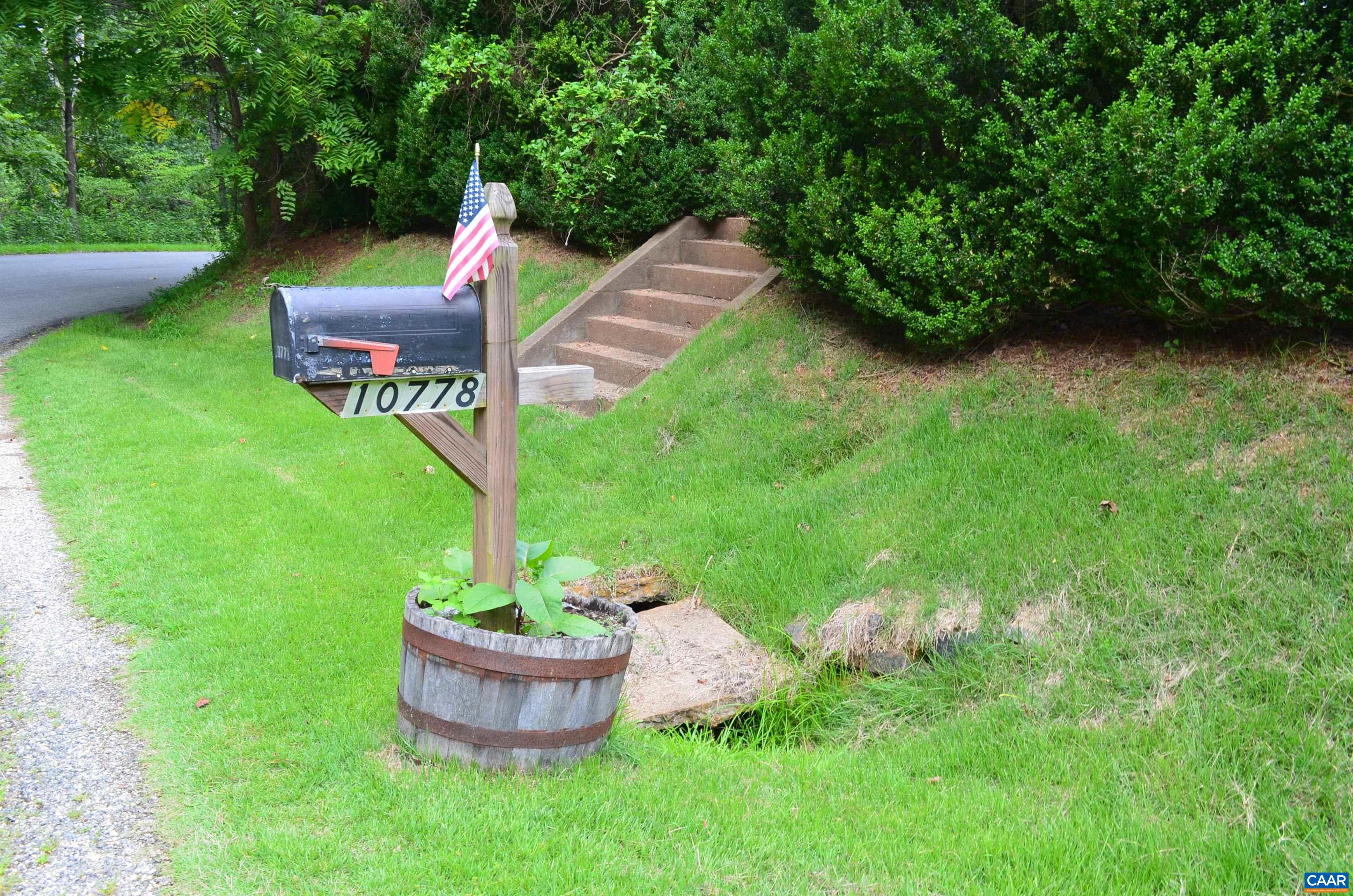 10778 Rockfish River Road Shipman, VA 22971 - Photo 10 of 67 a backyard of a house with table and chairs plants and large tree