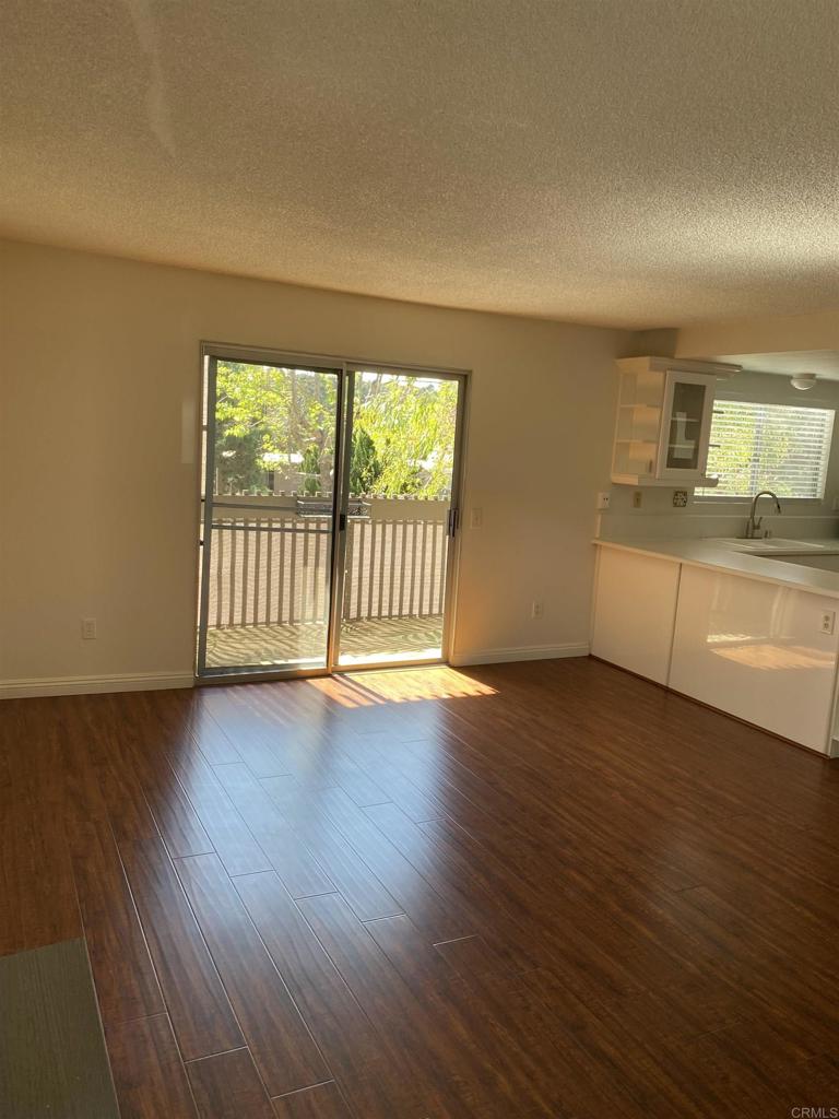 155 Rosebay Drive, Unit 42 Encinitas, CA 92024 - Photo 12 of 13 a view of empty room with wooden floor and fan