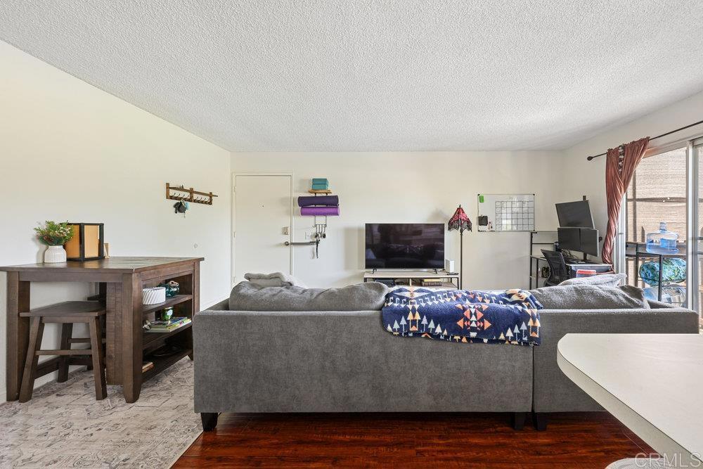 155 Rosebay Drive, Unit 42 Encinitas, CA 92024 - Photo 3 of 13 a living room with furniture and a flat screen tv