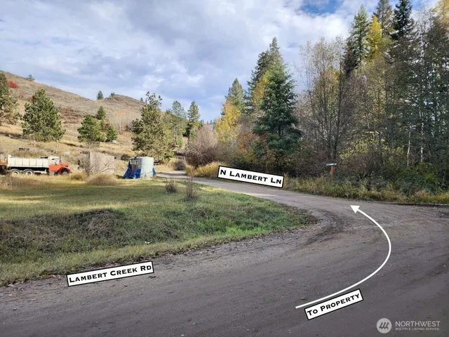 a view of a street with a building and car parked