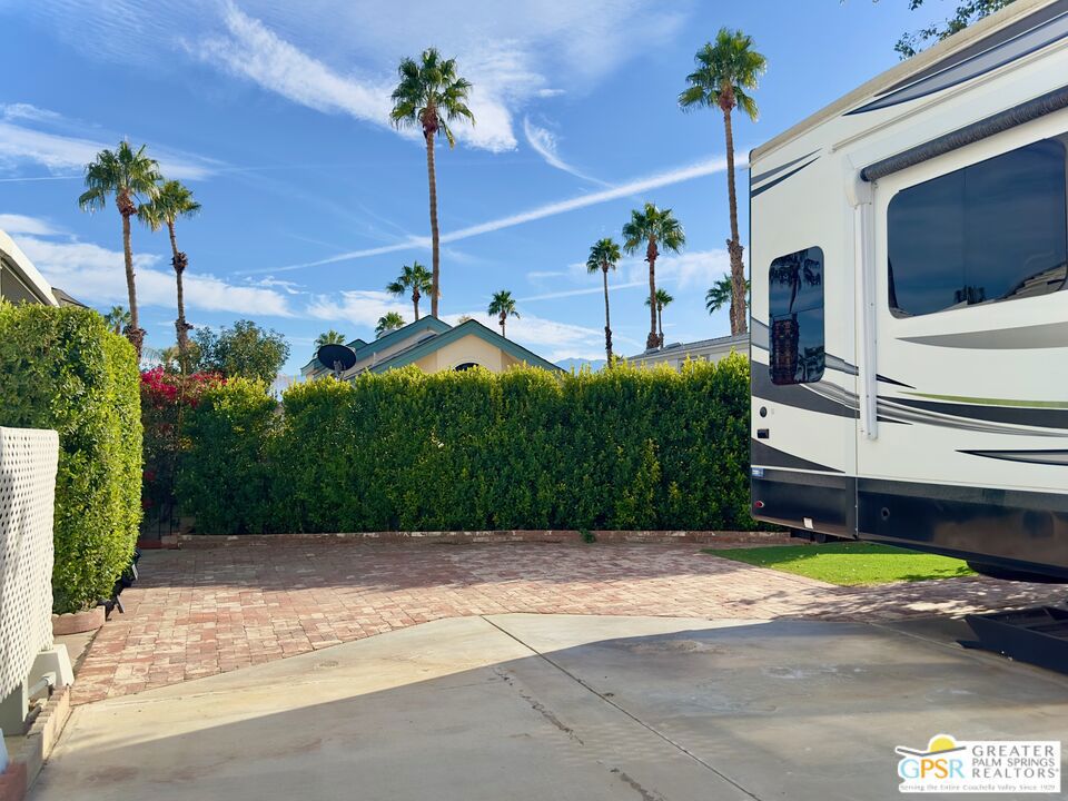 69801 Ramon Road, Unit 201 Cathedral City, CA 92234 - Photo 5 of 7 a front view of a house with a garden and yard