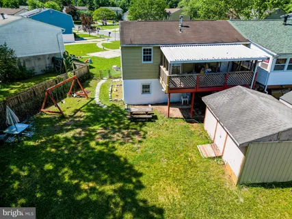 an aerial view of a house with swimming pool garden and patio