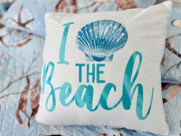 a living room with furniture and large windows