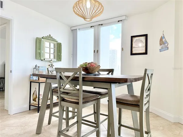 a view of a dining room with furniture and a potted plant