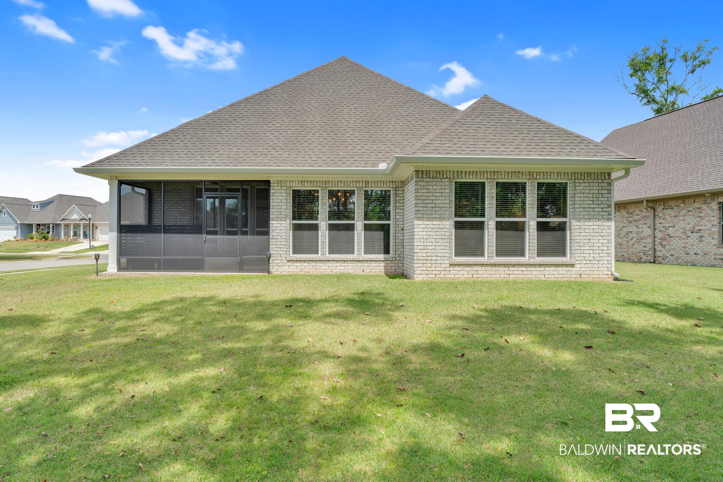 31630 Canopy Loop Daphne, AL 36527 - Photo 20 of 30 Back of house featuring a lawn, a shingled roof, a sunroom, and brick siding