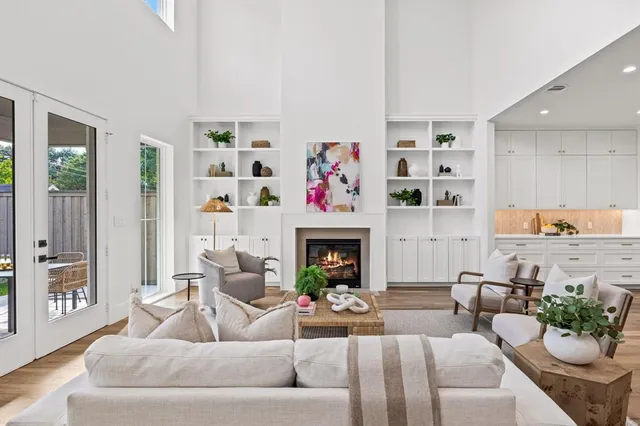 a living room with furniture fireplace and potted plant