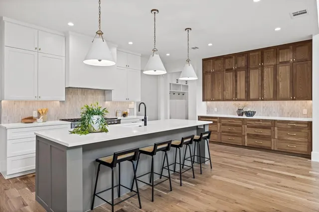 a kitchen with a sink stove and cabinets
