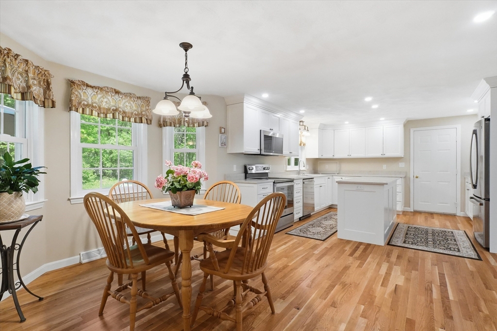 9 Fazio Farm Road Georgetown, MA 01833 - Photo 11 of 42 a dining room with furniture a chandelier and wooden floor