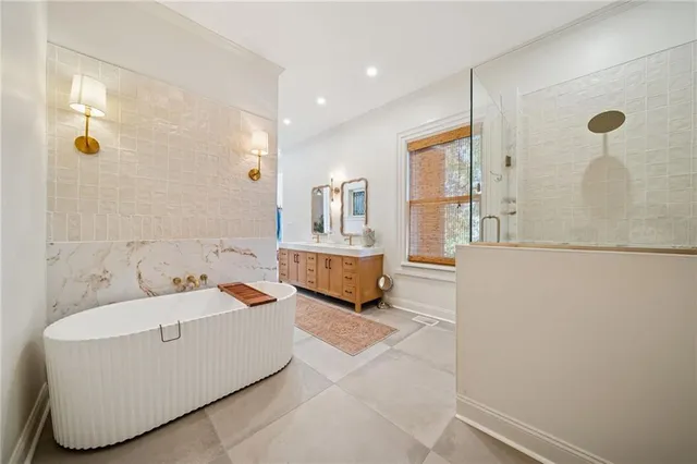 a bathroom with a tub sink and mirror