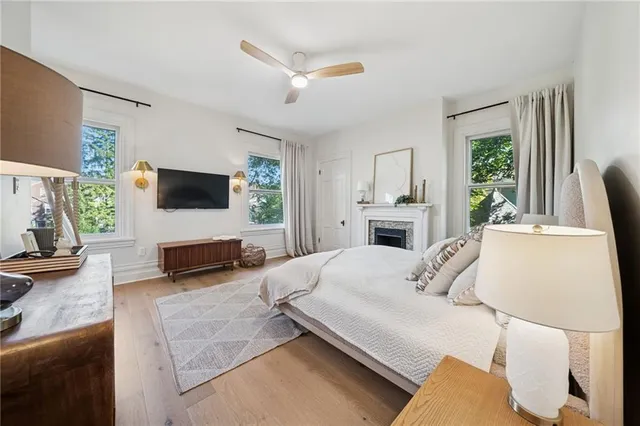 a bedroom with a bed window and a fireplace