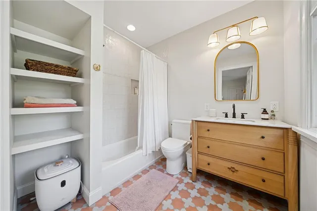 a bathroom with a sink mirror and toilet