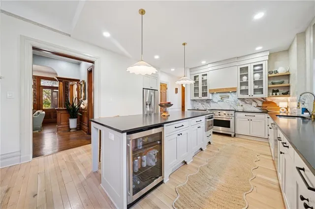 a kitchen with stainless steel appliances granite countertop a sink a stove top oven a counter space and cabinets