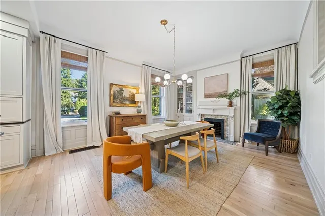 a dining room with furniture a chandelier and wooden floor