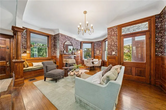 a living room with furniture windows and wooden floor