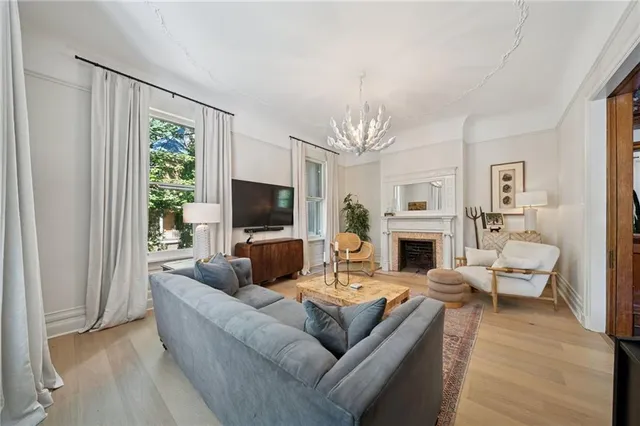a living room with furniture a fireplace and a flat screen tv