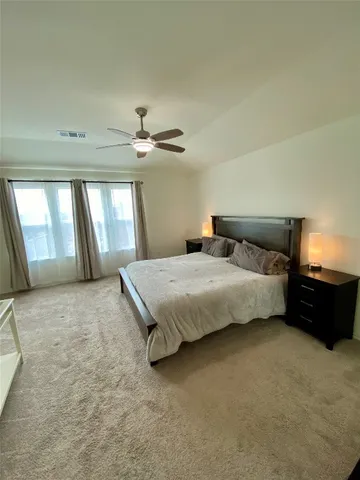 a bedroom with a bed and window