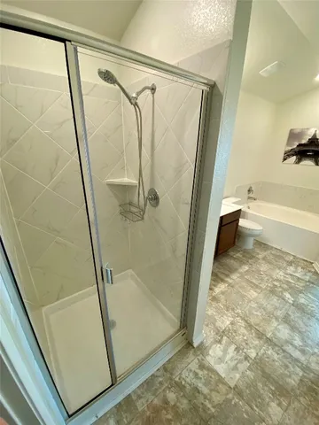 a bathroom with a glass shower door