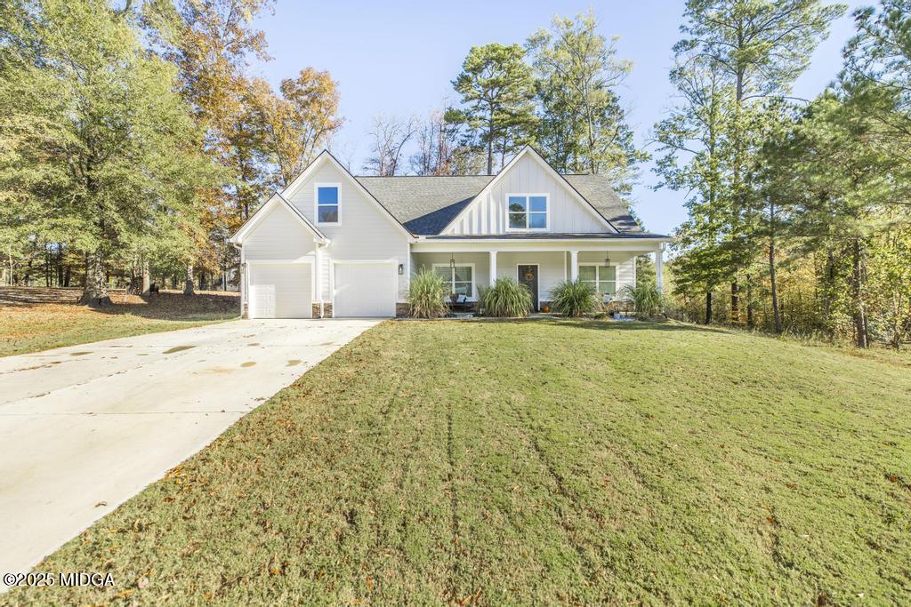 219 Diamond Place Gray, GA 31032 - Photo 1 of 42 a front view of a house with a yard and trees