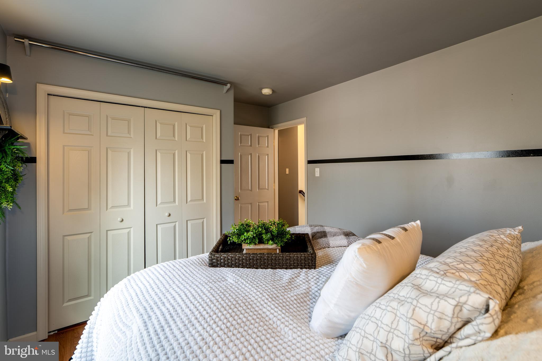 231 Owl Hill Road Lititz, PA 17543 - Photo 56 of 77 a bedroom with a bed and a potted plant