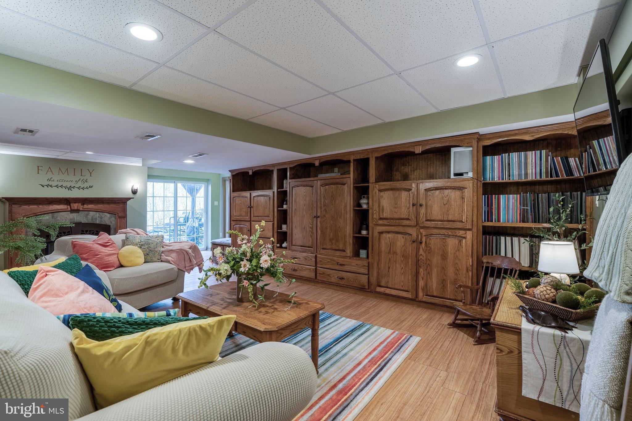 231 Owl Hill Road Lititz, PA 17543 - Photo 61 of 77 a living room with furniture a bookshelf and a book shelf