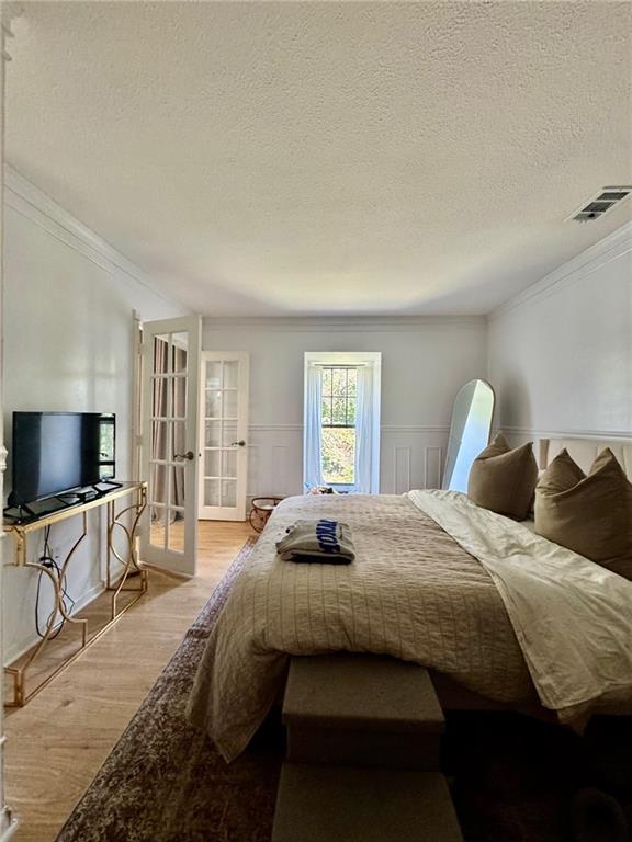 24311 Plantation Drive Northeast Atlanta, GA 30324 - Photo 13 of 31 a bedroom with bed tv and window