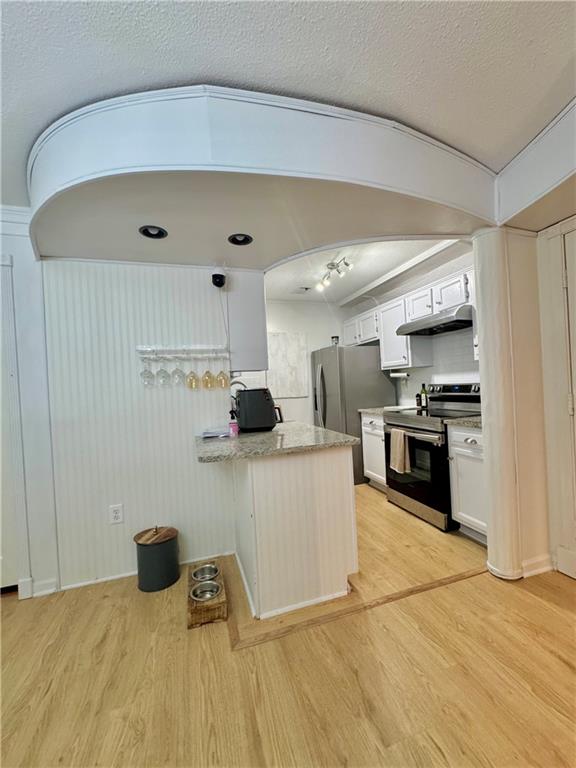 24311 Plantation Drive Northeast Atlanta, GA 30324 - Photo 16 of 31 a kitchen with stainless steel appliances a refrigerator and a stove top oven