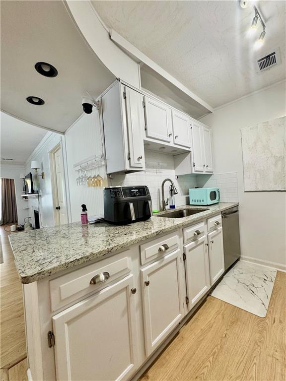 24311 Plantation Drive Northeast Atlanta, GA 30324 - Photo 18 of 31 a kitchen with granite countertop a sink stainless steel appliances and cabinets