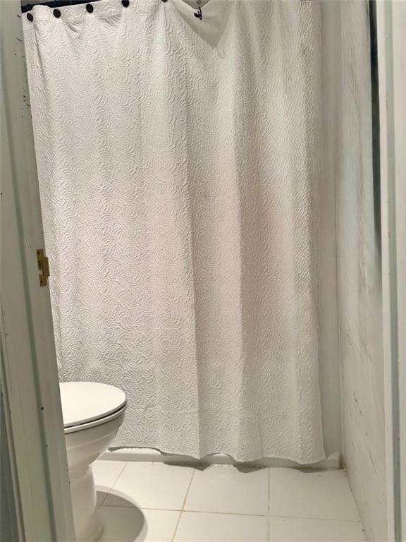 24311 Plantation Drive Northeast Atlanta, GA 30324 - Photo 23 of 31 a white toilet sitting next to a shower