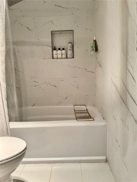 24311 Plantation Drive Northeast Atlanta, GA 30324 - Photo 24 of 31 a bathroom with a bathtub and a toilet