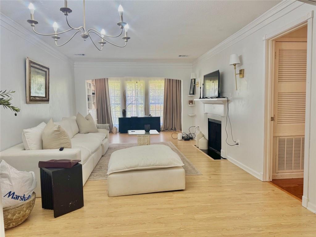 24311 Plantation Drive Northeast Atlanta, GA 30324 - Photo 5 of 31 a spacious bedroom with a large bed and a chandelier