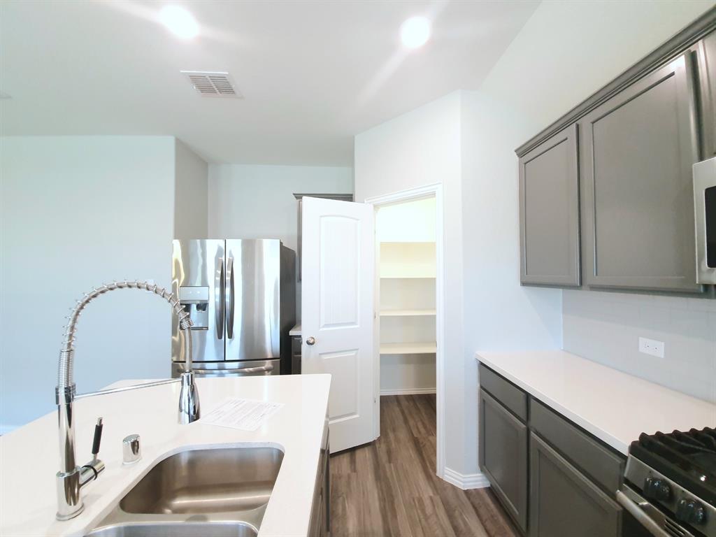 822 Spruce Lane Princeton, TX 75407 - Photo 11 of 35 a bathroom with a sink and a mirror