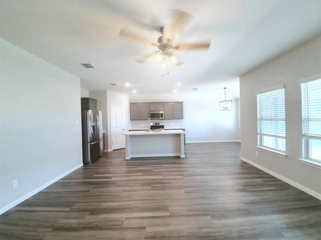 822 Spruce Lane Princeton, TX 75407 - Photo 19 of 35 a view of kitchen with wooden floor and window