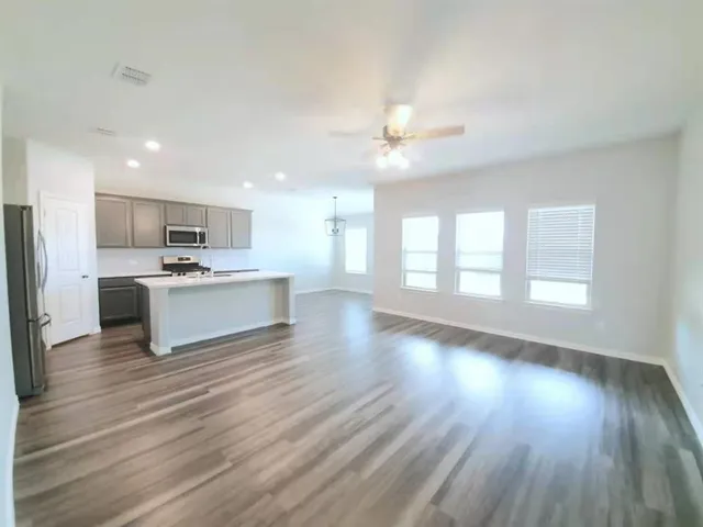 a view of kitchen with sink and wooden floor