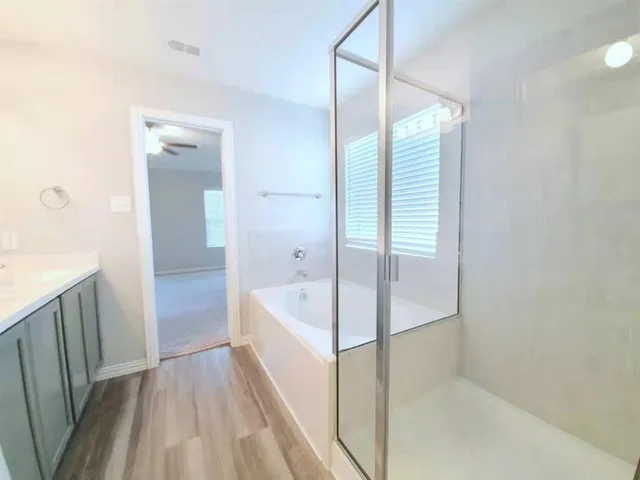 a bathroom with a bathtub and a shower