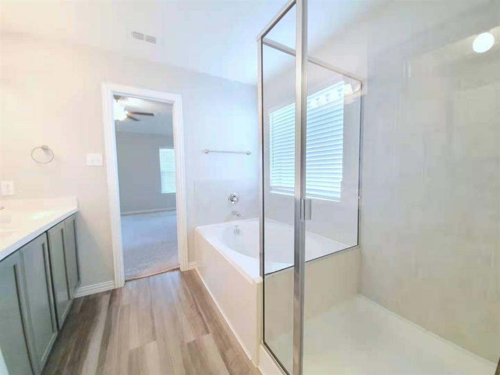 822 Spruce Lane Princeton, TX 75407 - Photo 25 of 35 a bathroom with a bathtub and a shower