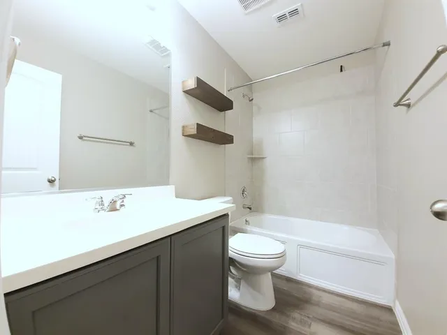 a bathroom with a sink a toilet and a bathtub