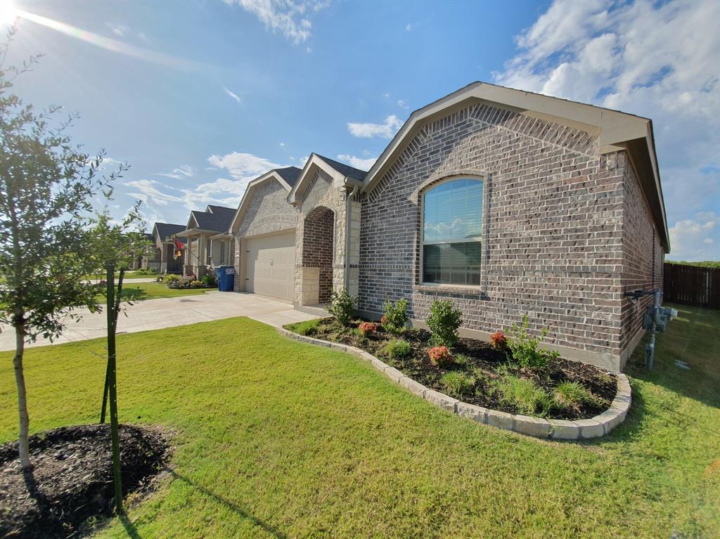 822 Spruce Lane Princeton, TX 75407 - Photo 3 of 35 a front view of a house with garden