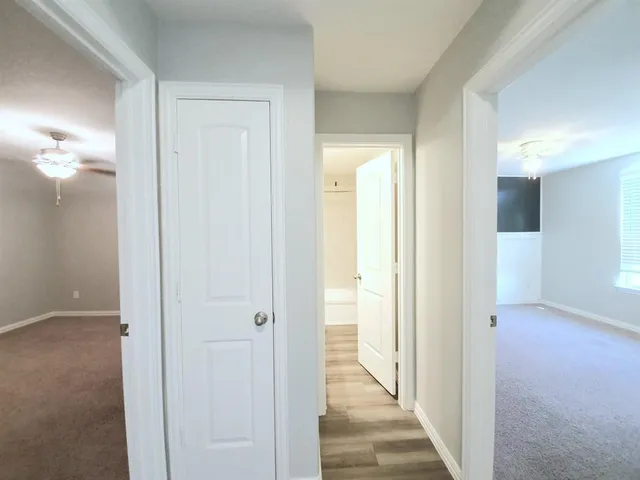a view of a hallway with a wooden door