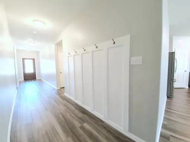 a view of a hallway with wooden floor