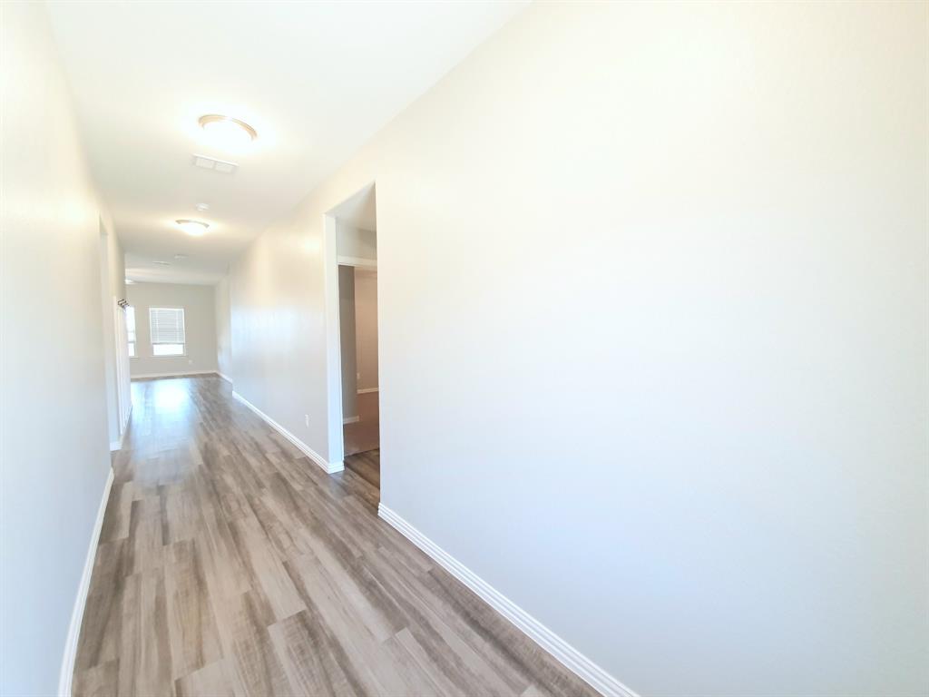 822 Spruce Lane Princeton, TX 75407 - Photo 7 of 35 a view of a room with wooden floor