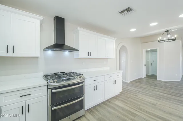a kitchen with granite countertop a stove and a sink