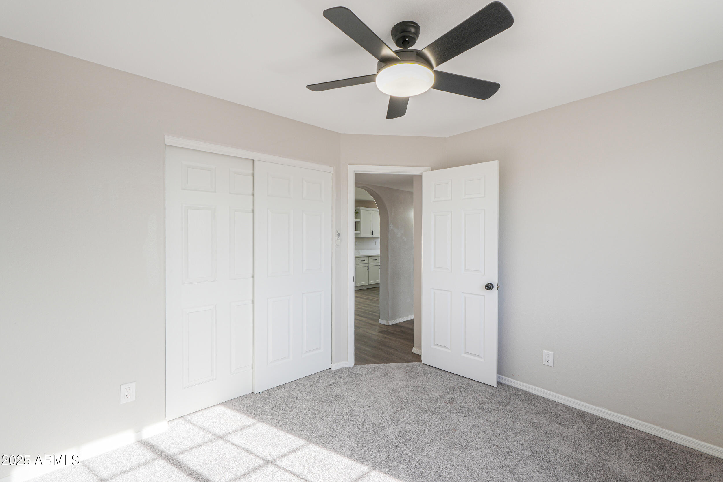 15741 Coral Road Arizona City, AZ 85123 - Photo 13 of 32 an empty room with closet and a chandelier fan