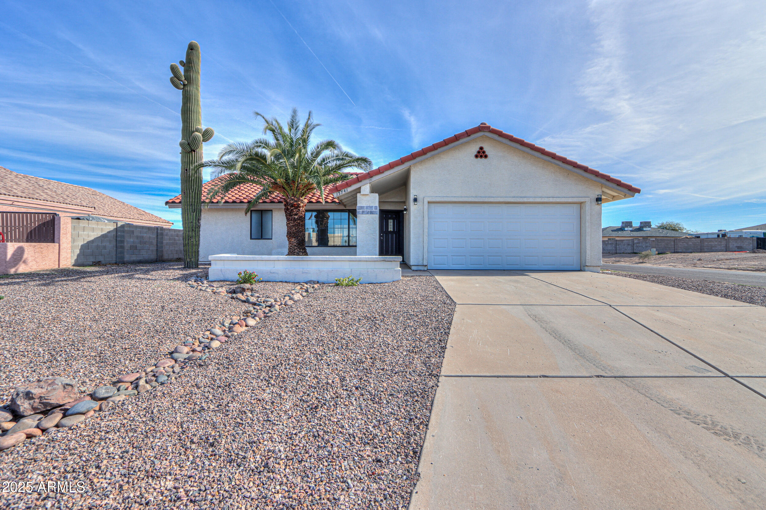 15741 Coral Road Arizona City, AZ 85123 - Photo 29 of 32 a front view of a house with a yard and garage