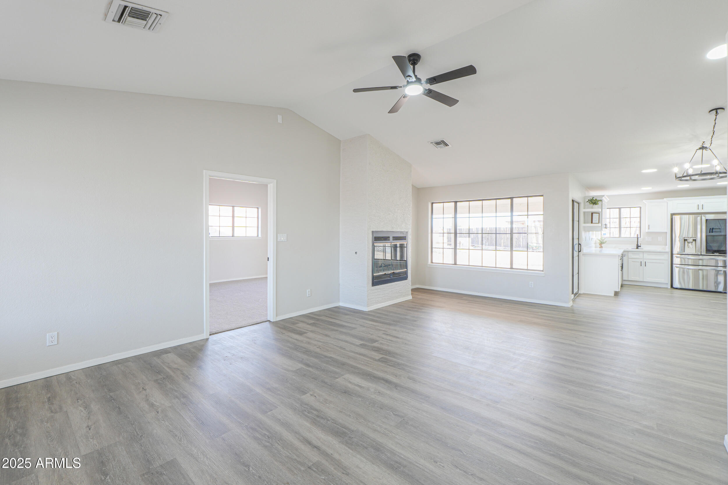 15741 Coral Road Arizona City, AZ 85123 - Photo 3 of 32 wooden floor in an empty room with a window