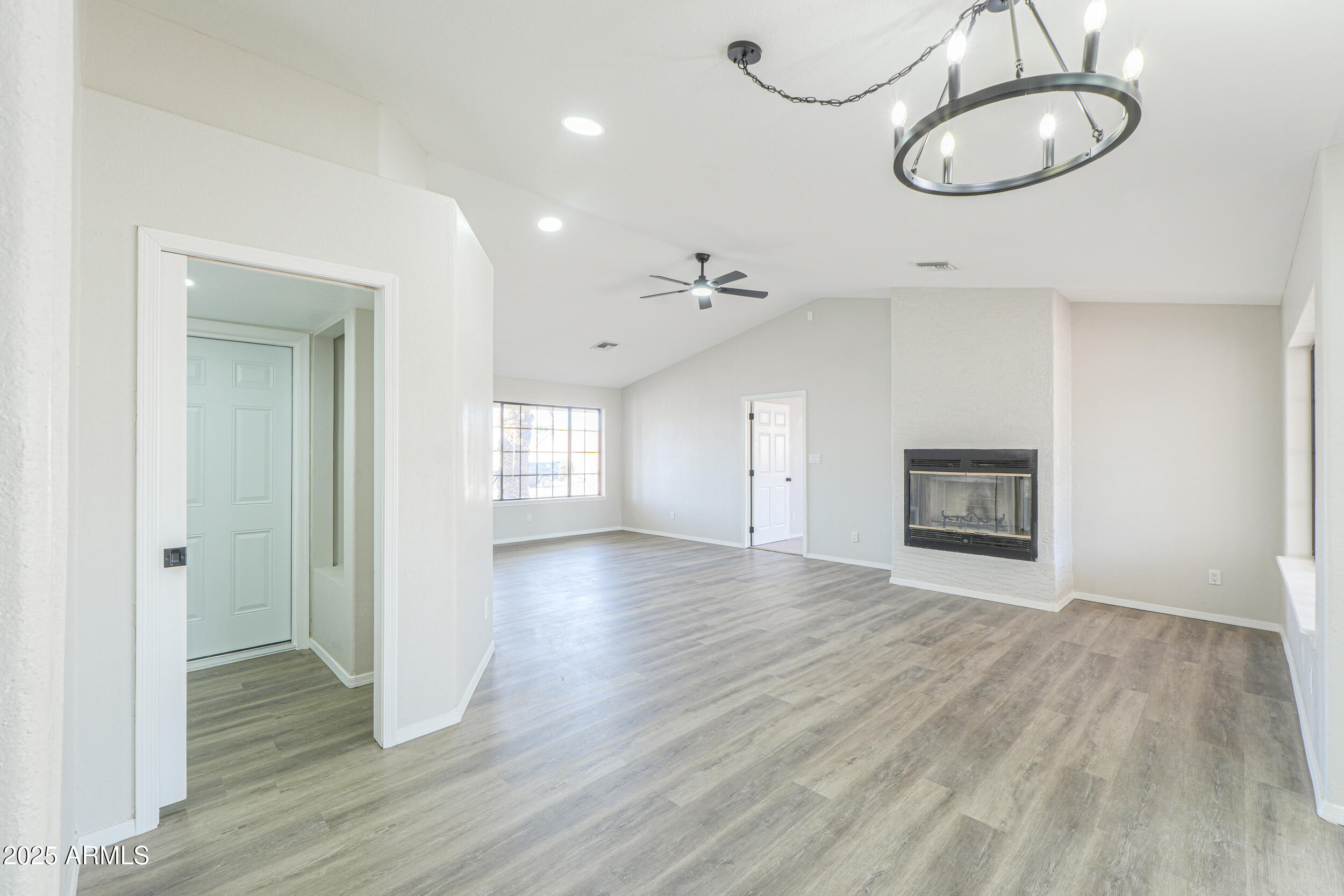 15741 Coral Road Arizona City, AZ 85123 - Photo 7 of 32 a view of an empty room with wooden floor and window