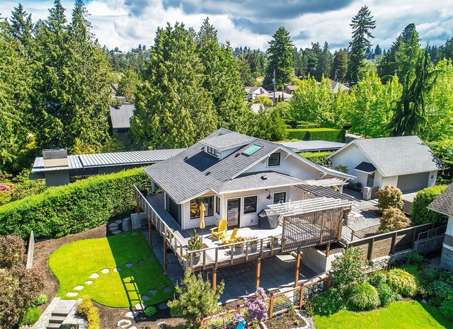 an aerial view of a house with swimming pool and garden