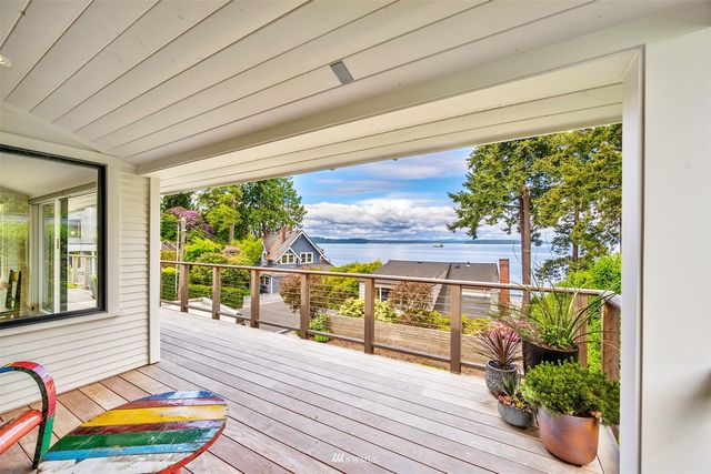 a balcony with furniture and potted plants